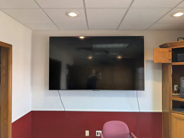 Large TV wall-mounted in an office conference room