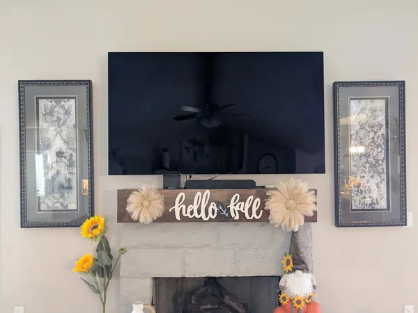 TV mounted over a stone fireplace